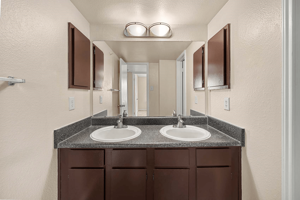 a bathroom with a sink and a mirror  at Collective on Riverside, Texas